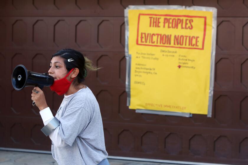 LOS ANGELES, CA - JUNE 23: Bianca A. speaks to a group of protestors standing outside Councilman Jose Huizar's home in Boyle Heights on Tuesday, June 23, 2020 in Los Angeles, CA. Federal agents brought long-awaited corruption charges against Councilman Jose Huizar - the second current or former member of the City Council to be accused of taking bribes from businessmen trying to buy special treatment. Protestors said he was a sellout of the community. (Dania Maxwell / Los Angeles Times)