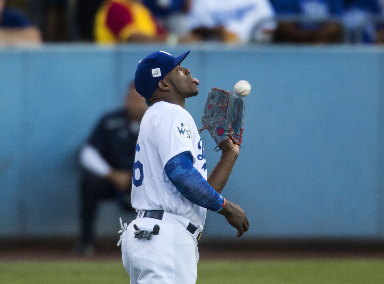 Dodgers right fielder Yasiel Puig catches a fly ball hit by Astros shortstop Carlos Correa with his tongue out during the first inning of Game 2.
