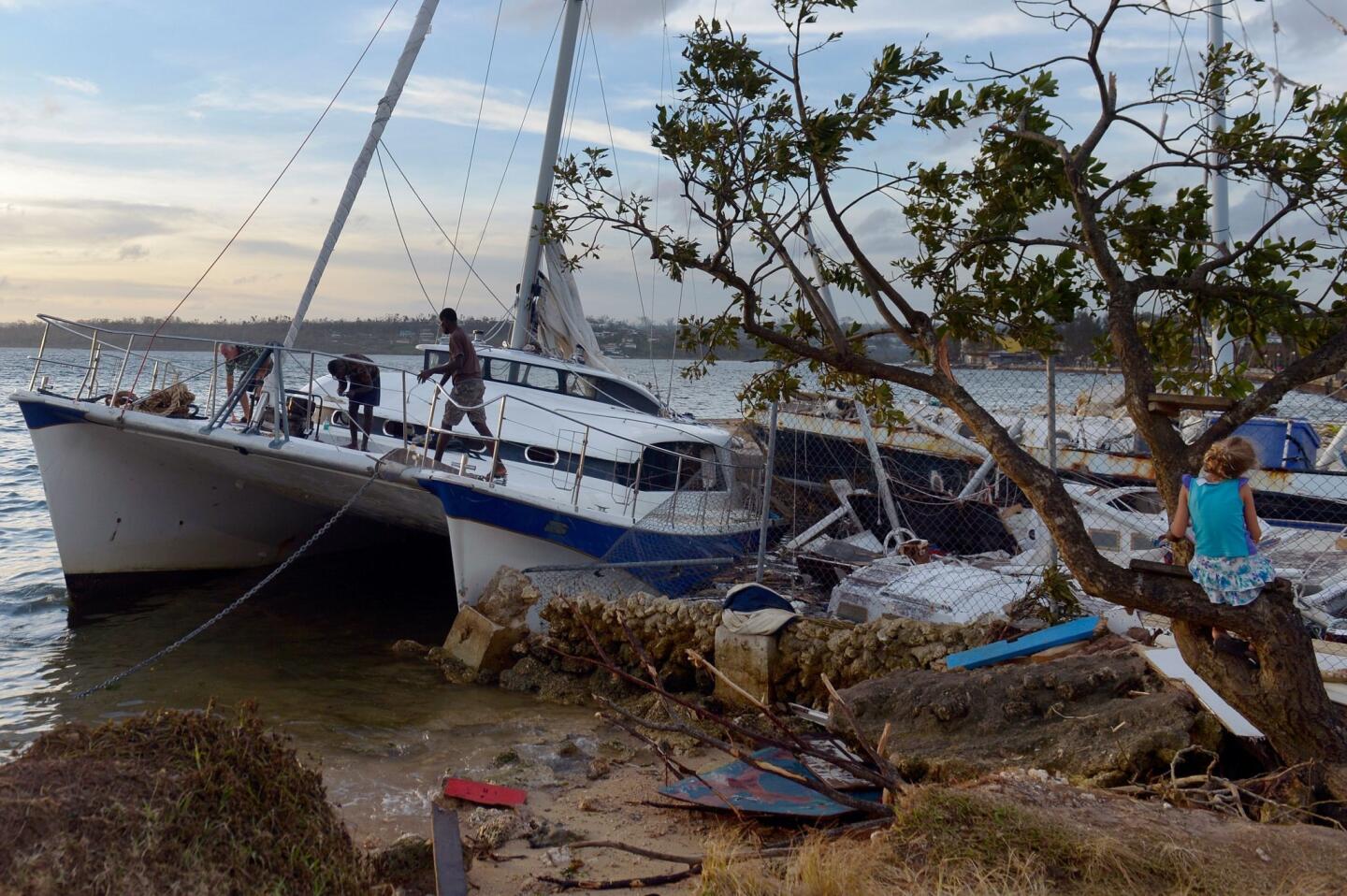 A boat that ran aground in Port Vila in cyclone-ravaged Vanuatu after Cyclone Pam tore through the area, packing wind gusts of up to 168 miles an hour.
