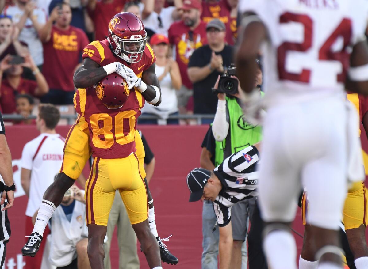 USC receiver Deontay Bennett (80) celebrates with running back Ronald Jones II after coming up with a touchdown grab against the Cardinal during the second quarter.