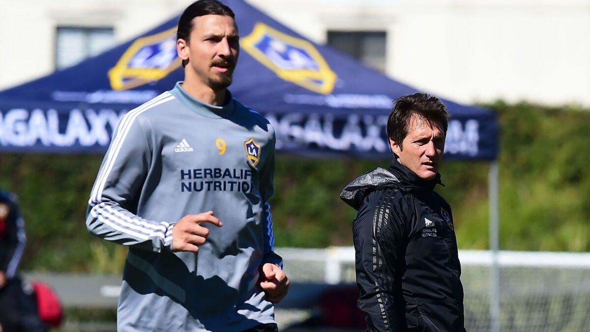 Zlatan Ibrahimovic participates in a Galaxy training session while coach Guillermo Barros Schelotto watches in Carson on Feb. 22.