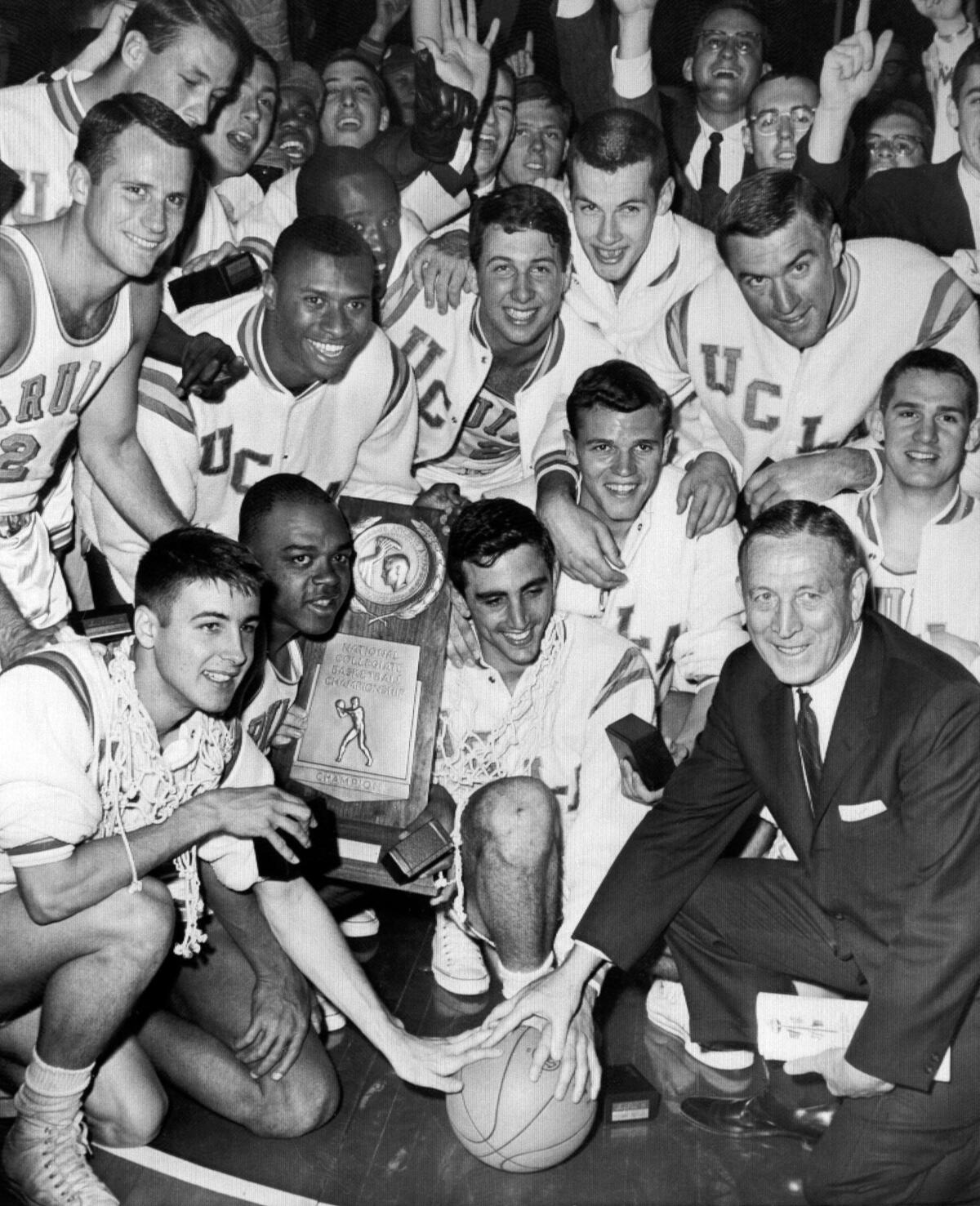 John Wooden and his UCLA team celebrate a win in 1964 with a group photo
