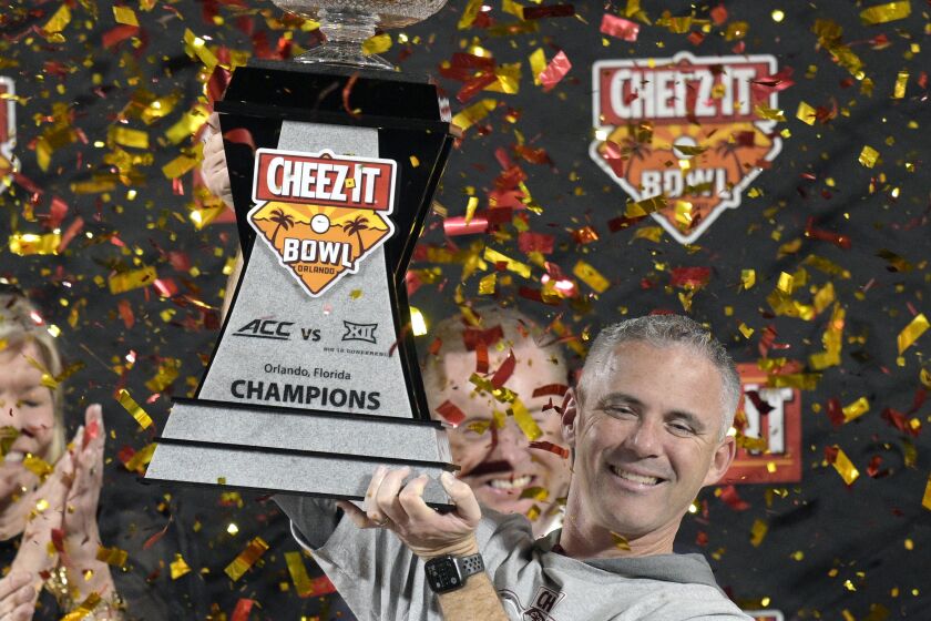 FILE - Florida State head coach Mike Norvell lifts the trophy after the team's win against Oklahoma in the Cheez-It Bowl NCAA college football game, on Dec. 29, 2022, in Orlando, Fla. Norvell, whose team ended last season with a six-game winning streak, was rewarded with a three-year contract extension that will pay him an average of $8.05 million annually through 2029, rhe school announced Wednesday, Feb. 8, 2023. (AP Photo/Phelan M. Ebenhack, File)