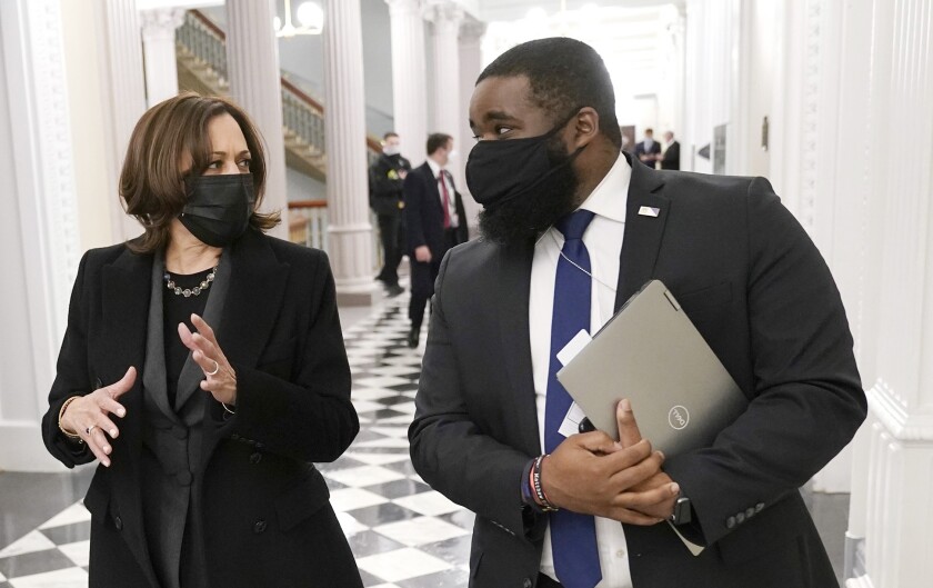 Vice President Kamala Harris with her aide, Vincent Evans, inside the Eisenhower Executive Office Building
