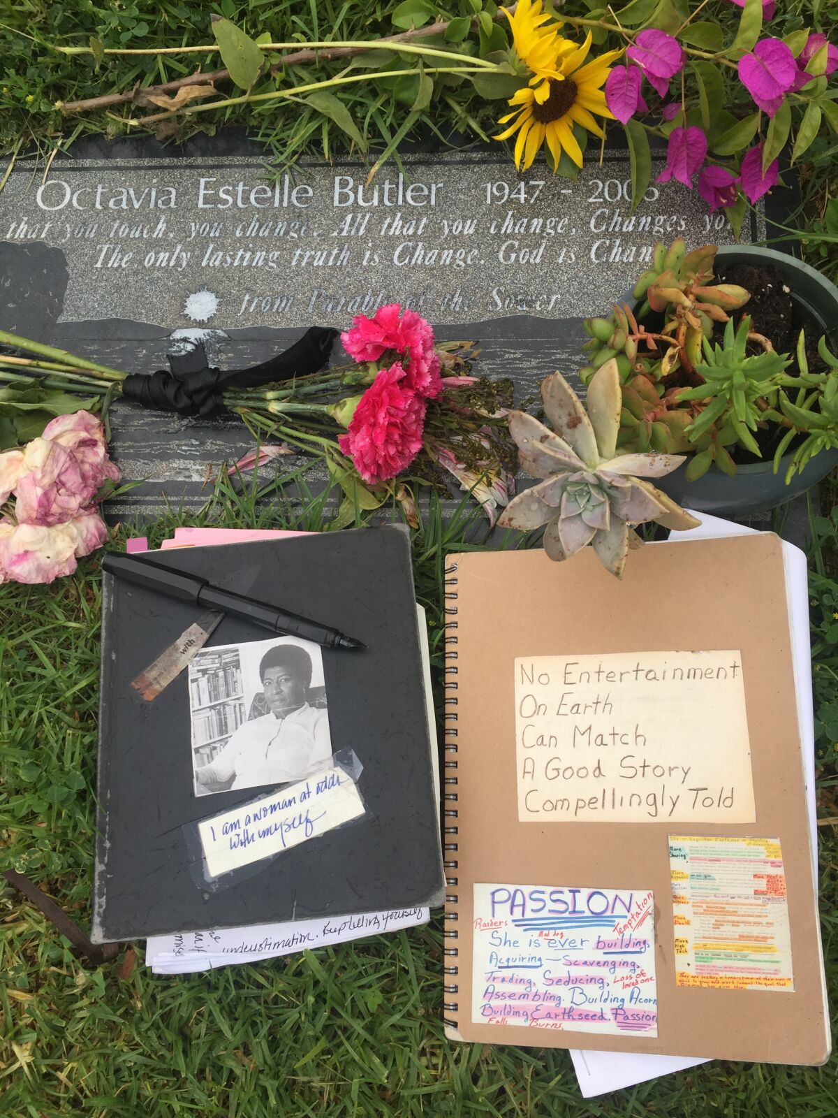Octavia E. Butler’s grave at Mountain View Cemetery in Altadena with her notebooks. 