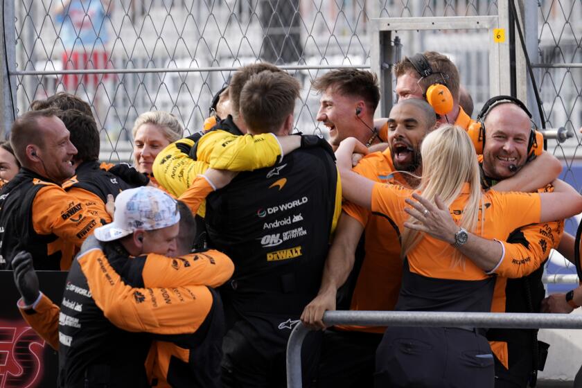 McLaren pit crew members celebrate after McLaren driver Lando Norris, of Britain, won the Formula One Miami Grand Prix auto race Sunday, May 5, 2024, in Miami Gardens, Fla. (AP Photo/Rebecca Blackwell)
