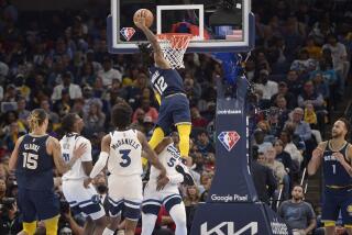 Memphis Grizzlies guard Ja Morant (12) dunks the ball against Minnesota Timberwolves guard Malik Beasley (5) in the second half during Game 5 of a first-round NBA basketball playoff series Tuesday, April 26, 2022, in Memphis, Tenn. (AP Photo/Brandon Dill)