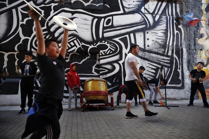 MEXICALI, MEX-MARCH 8, 2020: Emmanuel Samano Arrreola, fourth right, leads a drumming performance at La Chinesca alley on March 8, 2020, in Mexicali, Mexico. The city has coined their Chinatown, La Chinesca and has a large Chinese influence with the Chinese restaurants on many blocks. (Photo By Dania Maxwell / Los Angeles Times)