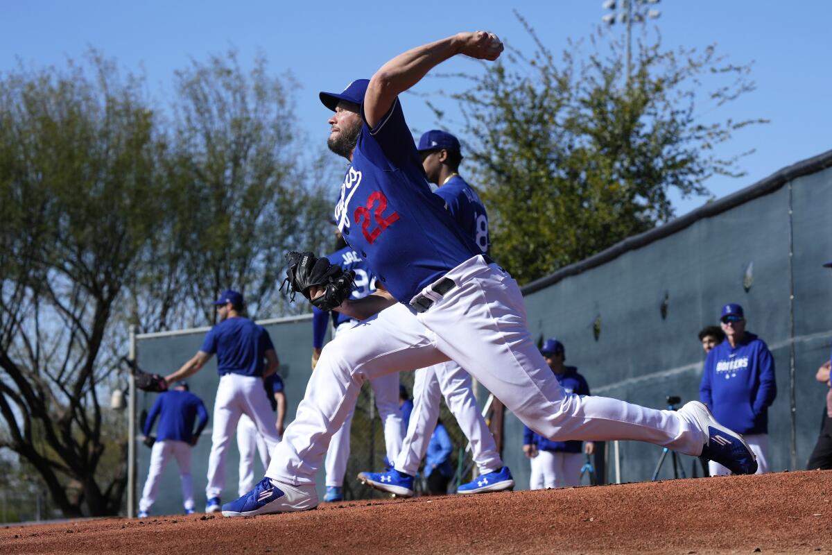 Clayton Kershaw throws a pitch during the first day of spring training workouts for Dodgers pitchers and catchers.