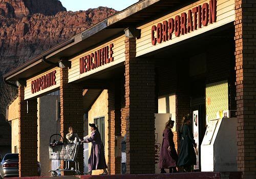 Women wearing the traditional long dress common in the polygamist enclave of Colorado City come and go at the town's main grocery store.