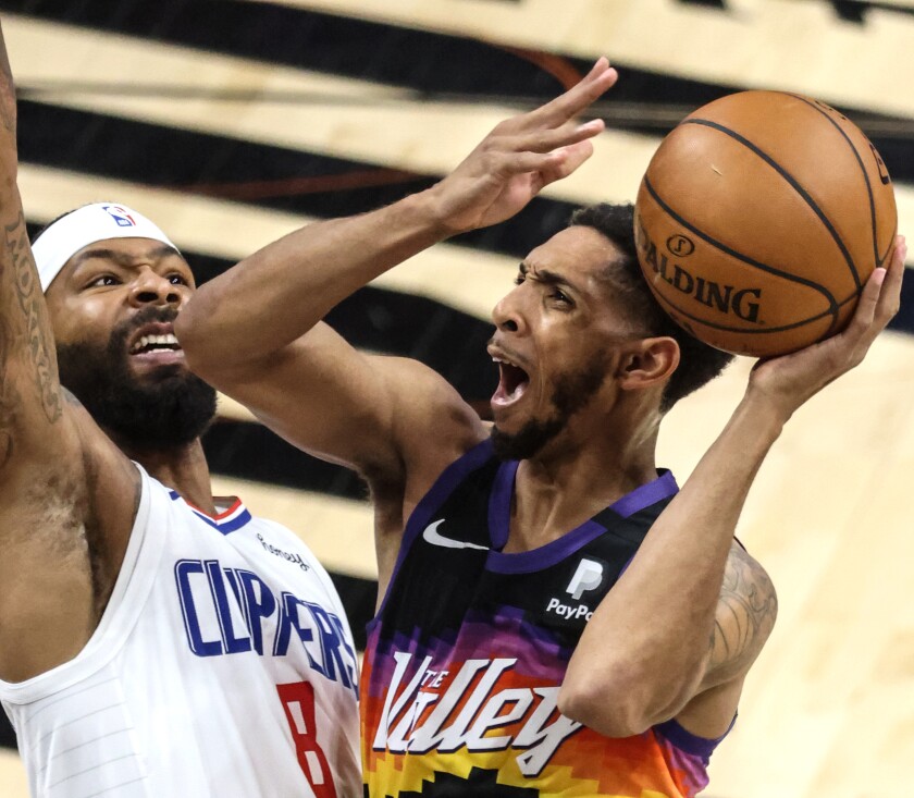 Phoenix Suns guard Cameron Payne shoots over Clippers forward Marcus Morris Sr.