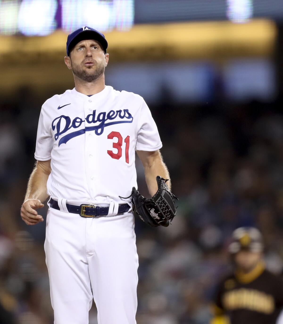 Dodgers pitcher Max Scherzer exhales before his windup.