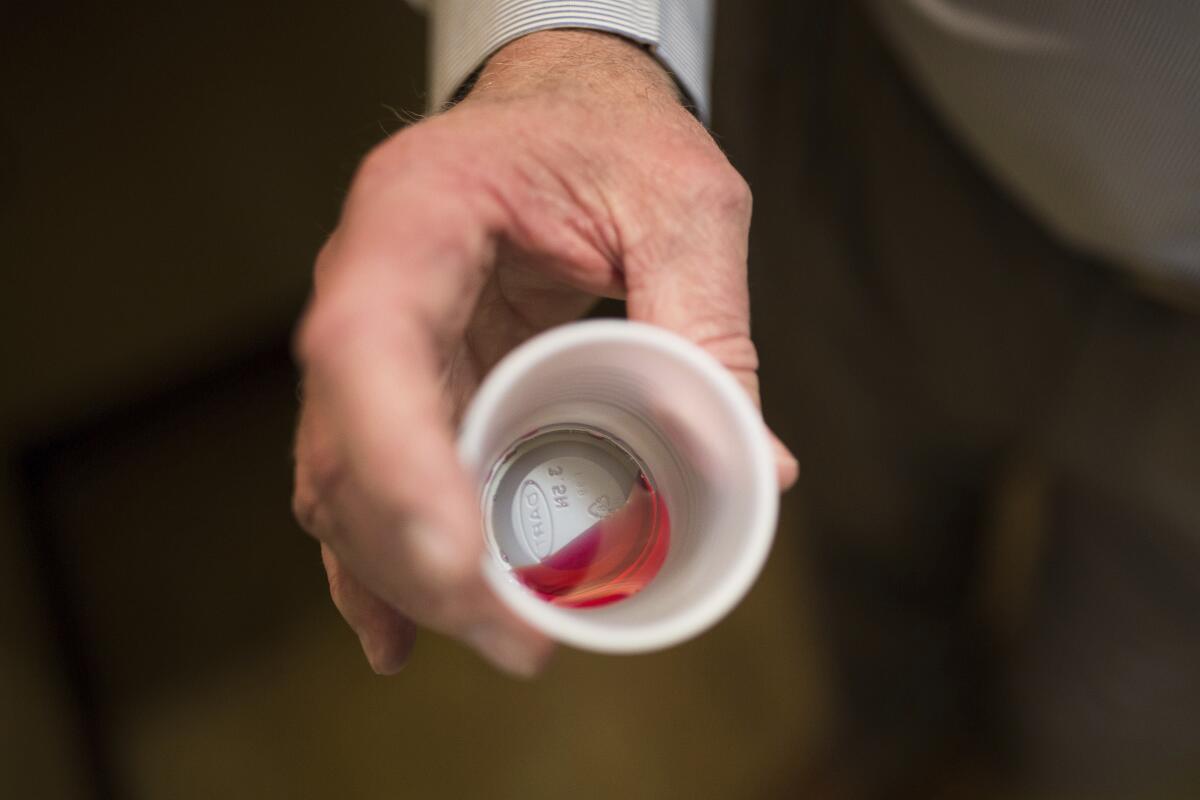 FILE - In this March 7, 2017 photo, Paul "Rip" Connell, CEO of Private Clinic North, a methadone clinic, shows a 35 mg liquid dose of methadone at the clinic in Rossville, Ga. In the spring of 2020, with coronavirus shutting down the nation, the government told methadone clinics they could allow stable patients to take their medicine at home unsupervised. Early research shows it didn't lead to surges of methadone overdoses or illegal sales. And the phone counseling that went along with take-home doses worked better for some people, helping them stay in recovery and get on with their lives. (AP Photo/Kevin D. Liles, File)
