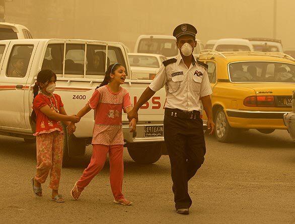 Masks help make the dust a little more bearable in Baghdad.