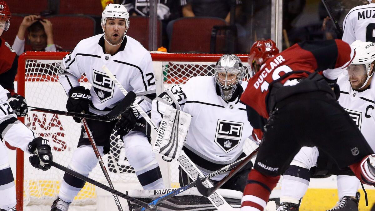 Alec Martinez and goalie Darcy Kuemper watch the flight of the puck shot by Arizona Coyotes left wing Anthony Duclair.