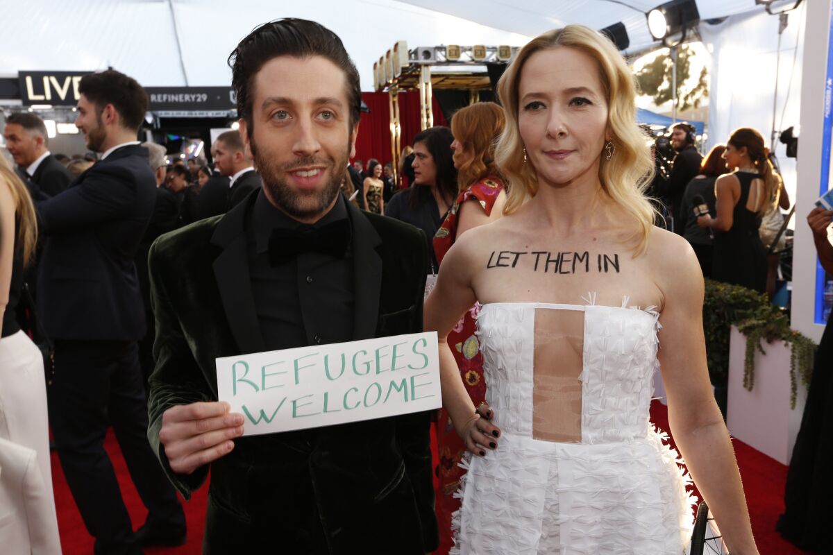 Simon Helberg of "The Big Bang Theory" and his wife, Jocelyn Towne, arrive at the SAG Awards.