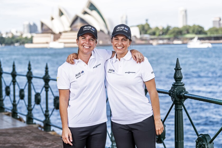 In this photo provided by SailGP are Nina Curtis, left, and Lisa Darmanin at Sydney Harbour in Australia on Wednesday, April 7, 2021. Four years ago, the closest Australian Olympic sailing medalists Darmanin and Curtis could get to the America's Cup was by taking jobs in a hospitality lounge on site in Bermuda. They'll be back in Bermuda in just a few days, this time with the defending champion Australian team in SailGP as part of a developmental program designed to fast-track the inclusion of women into the global league. (SailGP via AP)