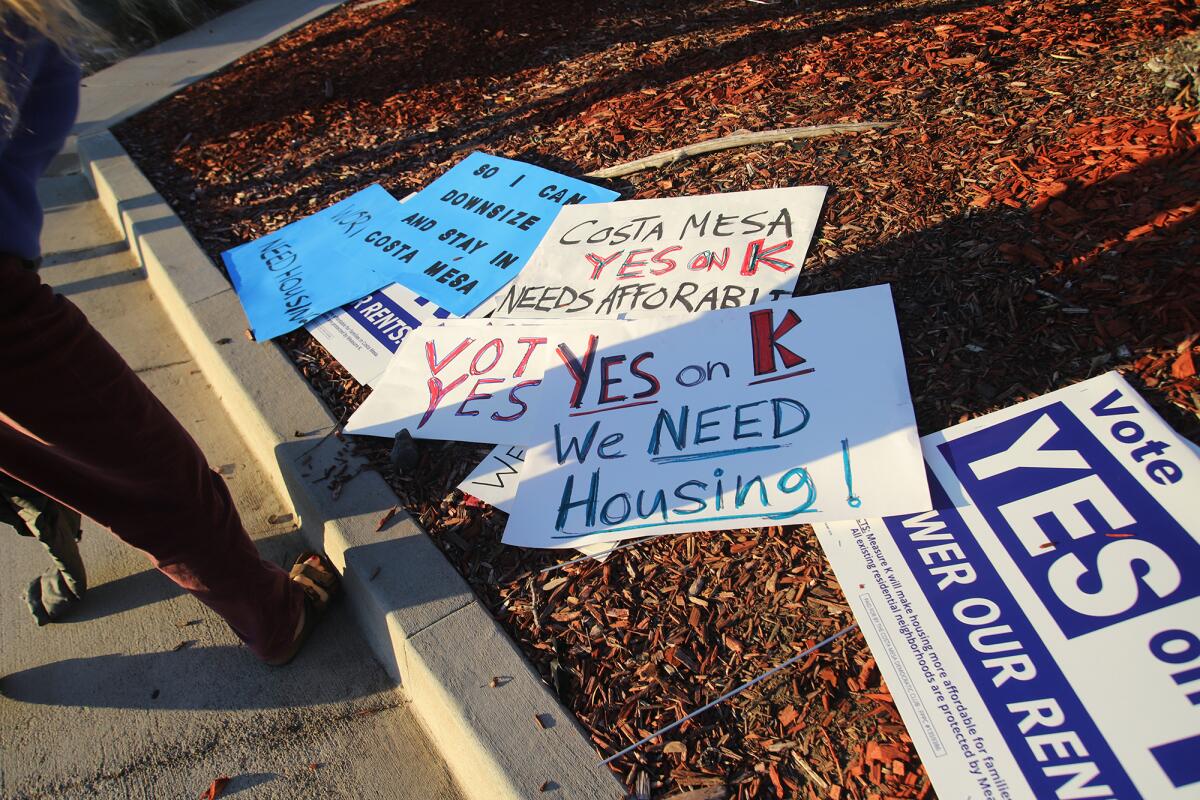 A collection of signs created for a Measure K rally at the intersection of Harbor Boulevard and Baker Street in Costa Mesa.