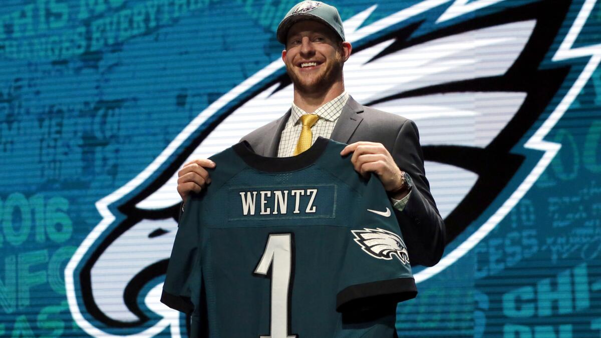 Carson Wentz poses for photos after being selected by the Philadelphia Eagles as the second overall pick in the NFL draft.