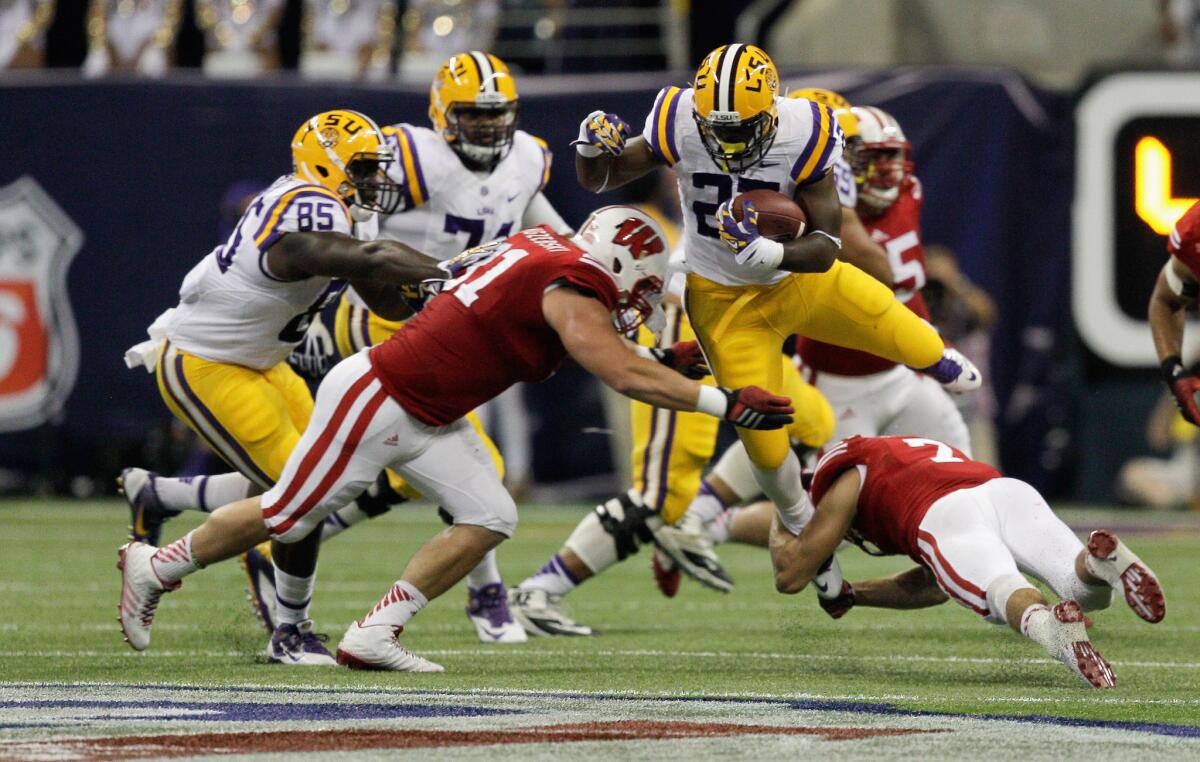 LSU's Kenny Hilliard is tackled by Wisconsin's Konrad Zagzebski, who was injured on the play and to be taken off on a stretcher.