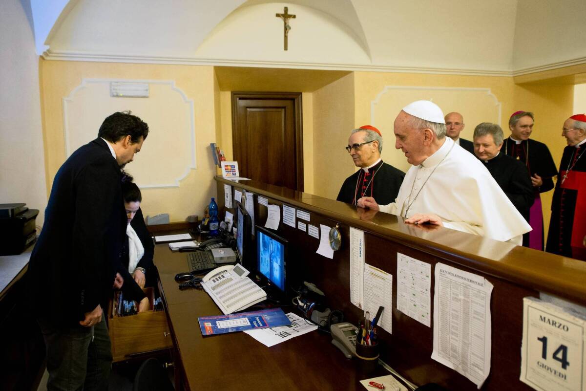 Pope Francis pays his own bill at the Rome residence where he stayed during the conclave of cardinals.