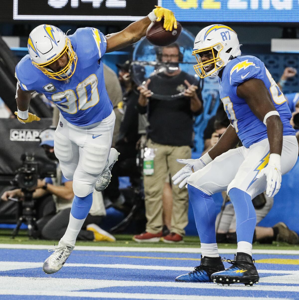  Chargers running back Austin Ekeler (30) scores a touchdown as teammate Jared Cook watches.