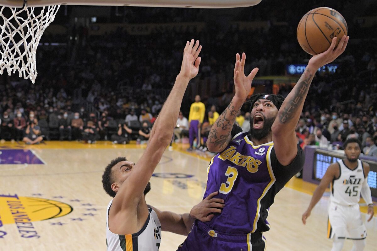 Lakers forward Anthony Davis shoots as Utah Jazz center Rudy Gobert defends.