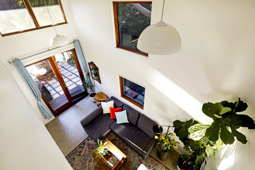 Looking down at the living room from a half wall bedroom/loft.