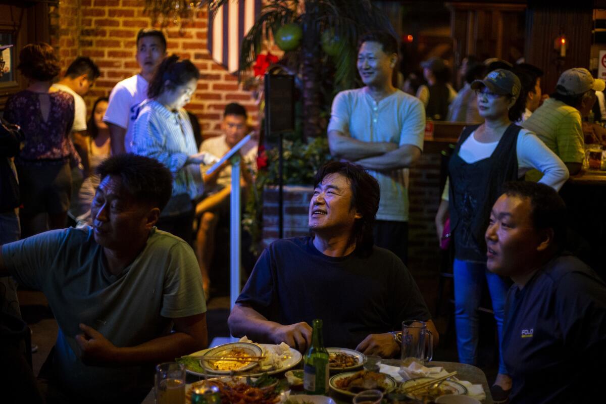 Patrons watch Game 1 of the National League Division Series between the Dodgers and the Atlanta Braves at OB Bear in Koreatown on Oct. 4, 2018. (Kent Nishimura / Los Angeles Times)