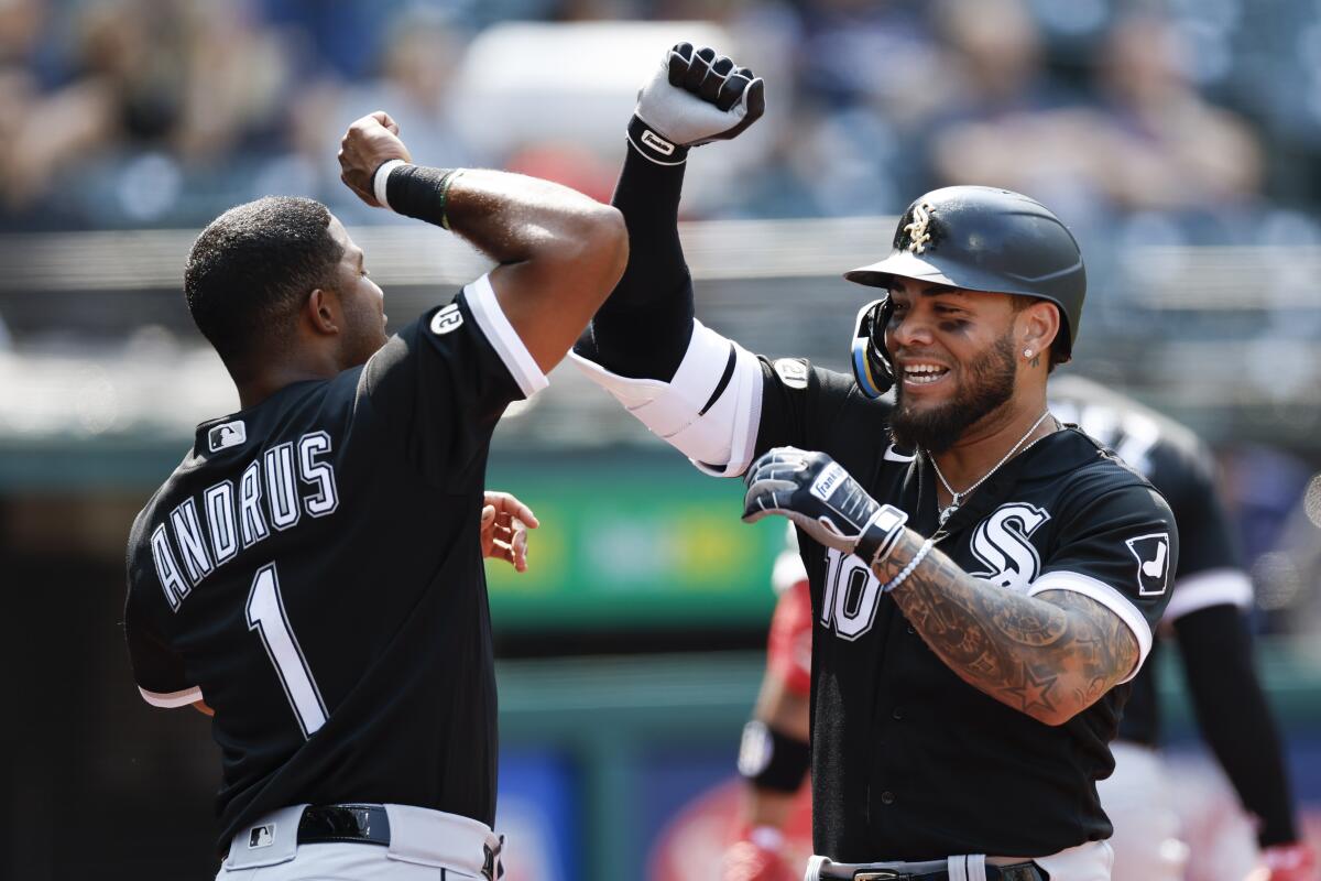 Chicago White Sox's Yoan Moncada (10) celebrates with Elvis Andrus after hitting a solo home run off Cleveland Guardians starting pitcher Hunter Gaddis during the third inning of a baseball game, Thursday, Sept. 15, 2022, in Cleveland. (AP Photo/Ron Schwane)