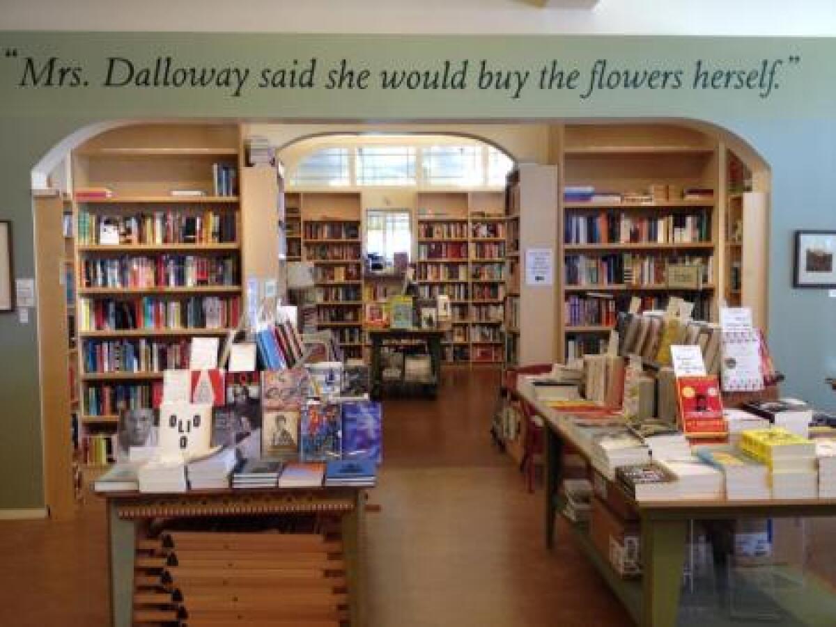 A bookstore with "Mrs. Dalloway said she would buy the flowers herself" written on the wall