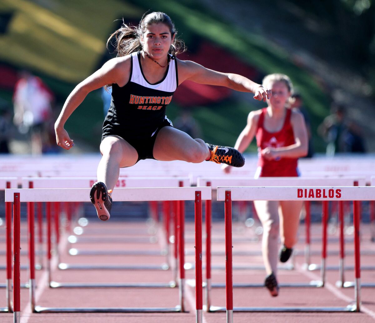 Huntington Beach's Kyli Moon-Rumsey competes in the 100-meter hurdles at the Orange County Championships at Mission Viejo High on April 13, 2019.