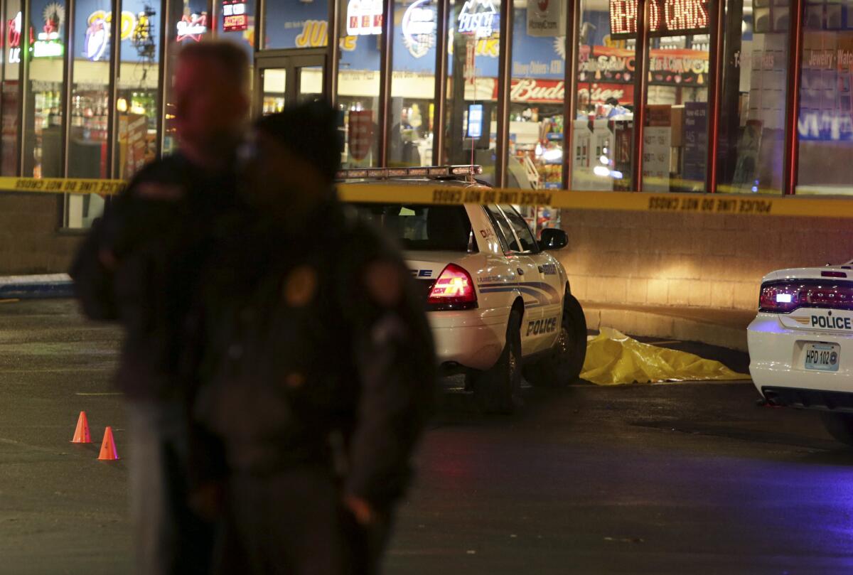 Police stand guard Wednesday outside a gas station in Berkeley, Mo., after an officer-involved shooting.