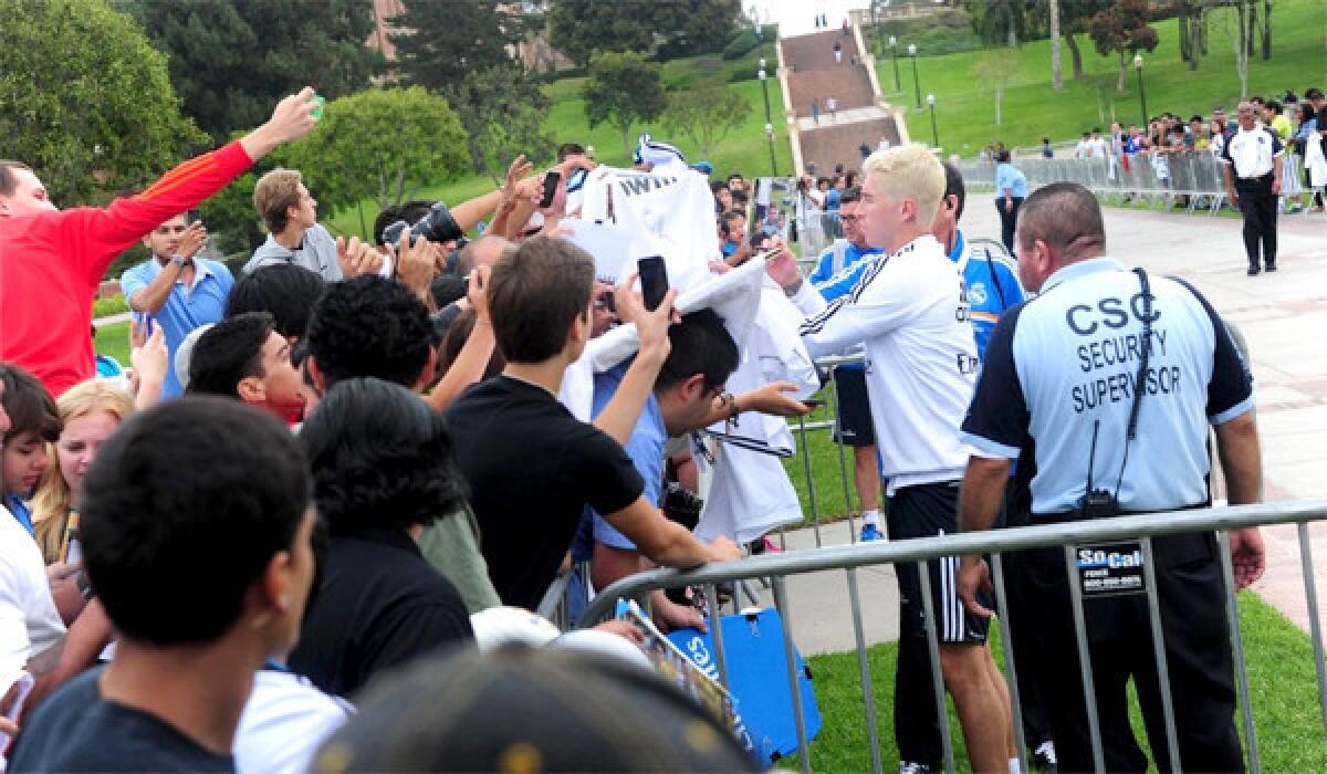 Sergio Ramos signs autographs for fans of the Real Madrid defender before a team practice at UCLA on Tuesday.