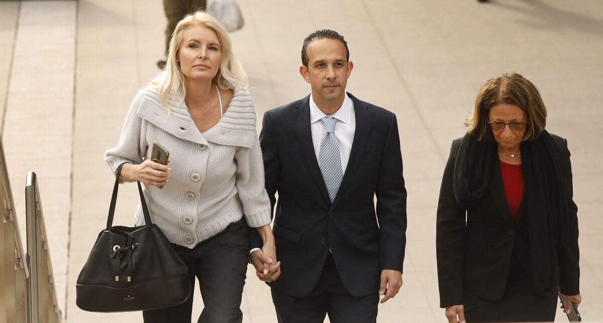 Mitchell Englander with his wife Jayne Englander and lead attorney Janet Levine.