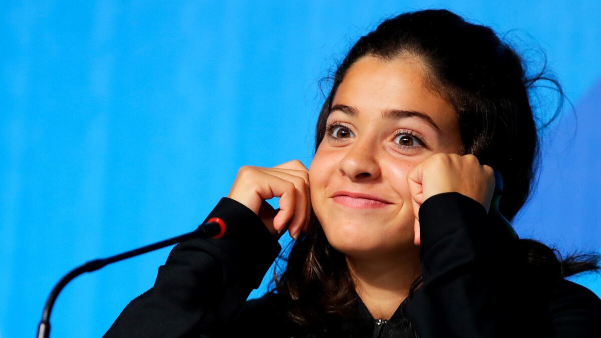 Syrian swimmer Yusra Mardini listens to a question during a news conference in Rio de Janeiro on Aug. 2.