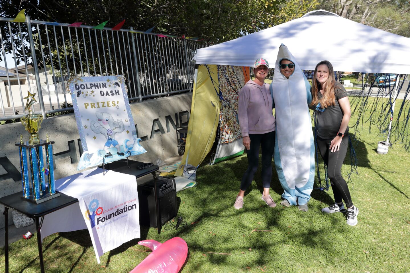 Dad's Club president Aaron Ling (center in dolphin costume) with Dolphin Dash co-chairs Emily Slade (left) and Katie Suel (right)