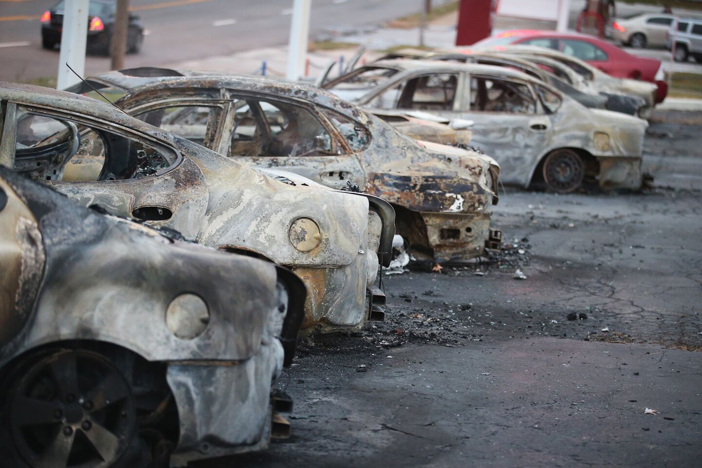 Cars, set on fire when rioting erupted after the grand jury announcement in the Michael Brown case, sit on a lot in Dellword, Mo.