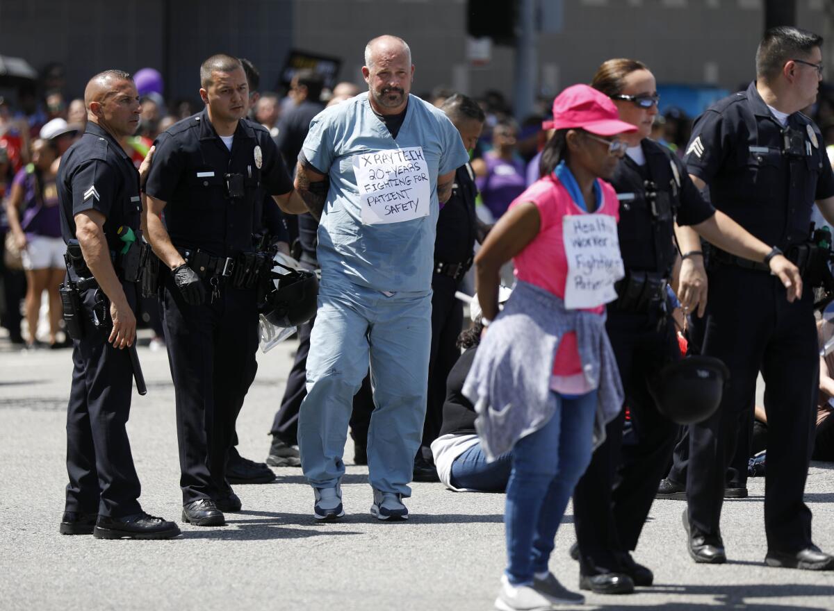 Los Angeles police arrest Kaiser Permanente workers and supporters at a protest last year.