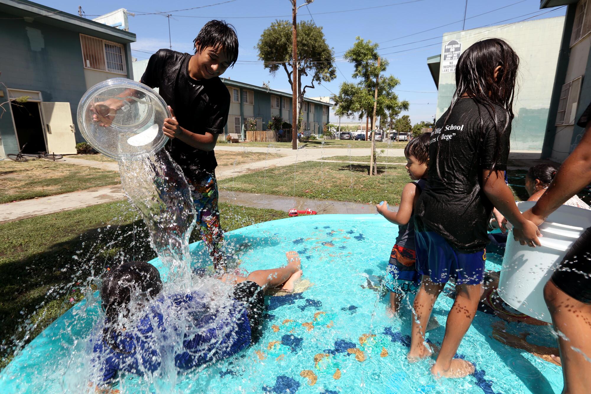 Children play in a wading pool. 