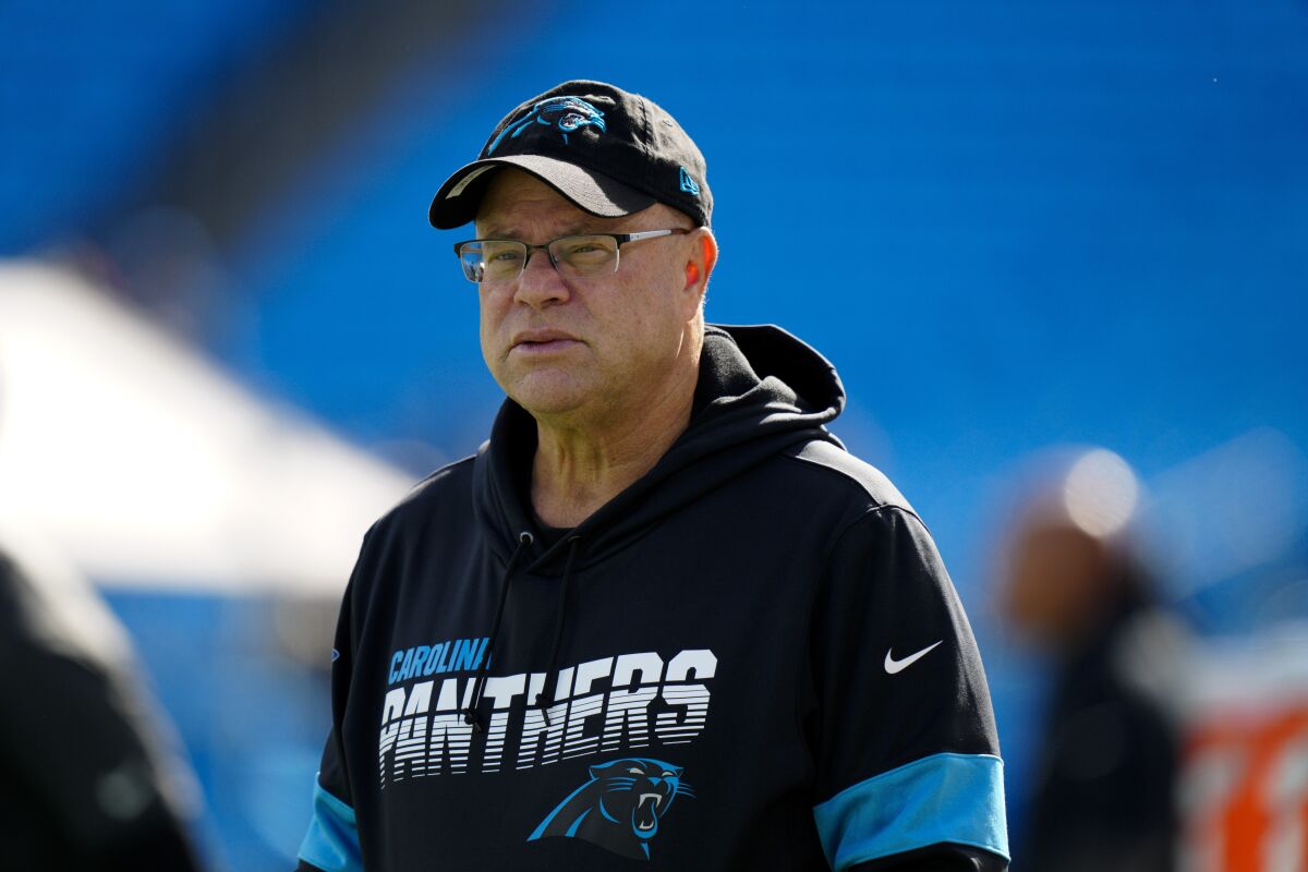 FILE - Carolina Panthers owner David Tepper watches during warm ups before an NFL football game against the New England Patriots, Sunday, Nov. 7, 2021, in Charlotte, N.C. South Carolina’s York County is suing Carolina Panthers owner David Tepper’s companies and the City of Rock Hill for at least $21 million over the failed completion of the team’s proposed $800 million practice facility and headquarters. The structure remains half-built in Rock Hill, South Carolina, with no plans of being finished.(AP Photo/Jacob Kupferman, File)