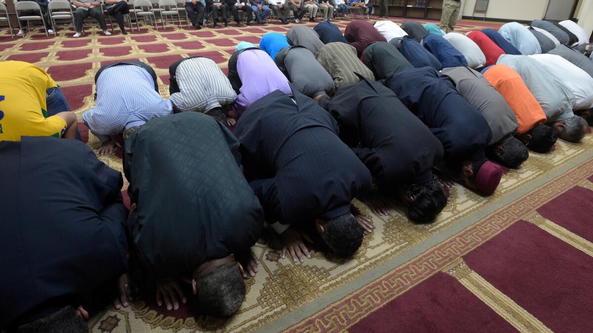 Muslims pray at the American Muslim Community Center in Longwood, Fla., on Monday after the mass shooting at the Pulse nightclub in Orlando.