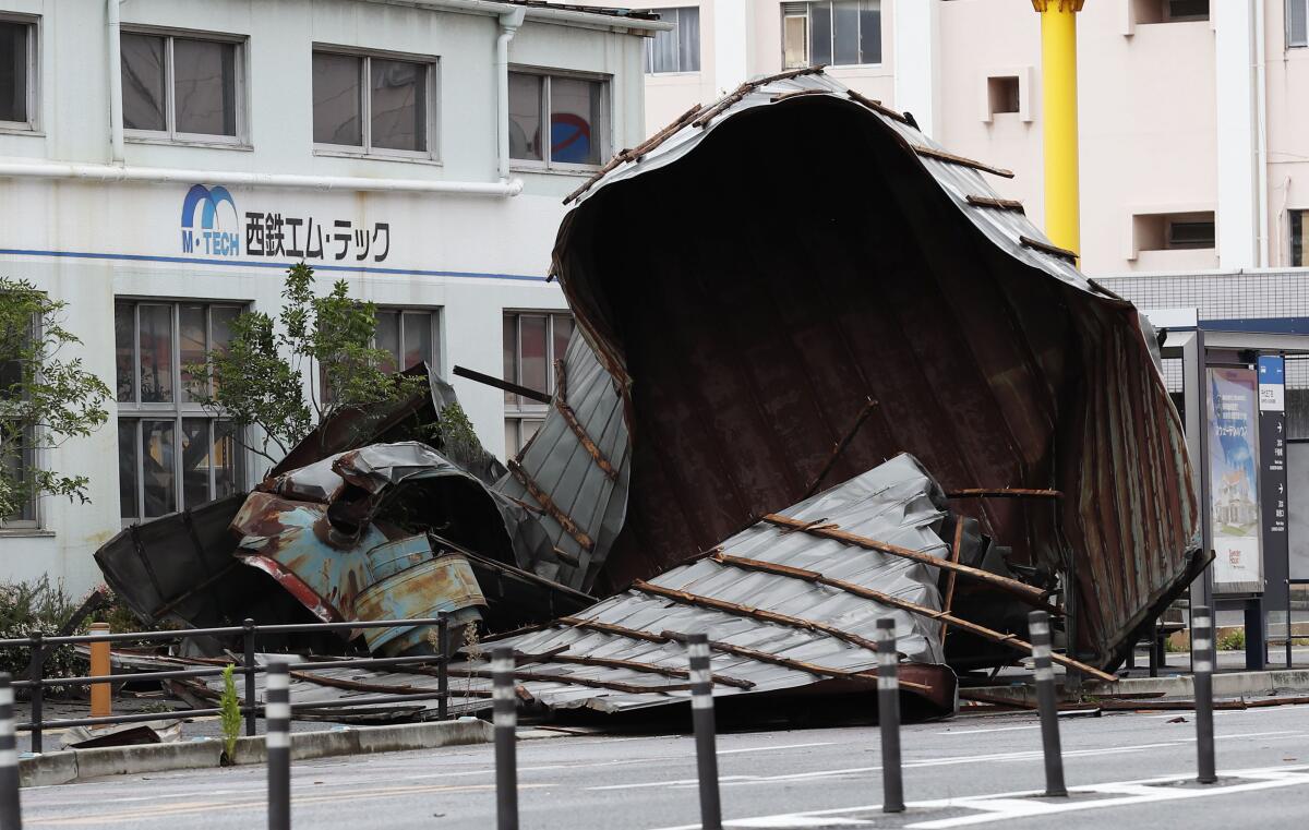 The roof of a car factory sits on a sidewalk after a typhoon hit Fukuoka, Japan Monday, on Monday.