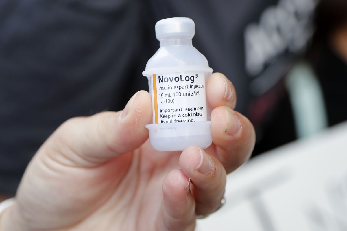 FILE - A patient holds a vial of insulin during a news conference outside the Olde Walkersville Pharmacy, July 28, 2019, in Windsor, Canada. Legislation to limit insulin costs for people with diabetes is getting a new push in the Senate. Democrats say they want to move quickly, but they'll need Republican support to get anything through an evenly divided chamber. (AP Photo/Carlos Osorio, File)