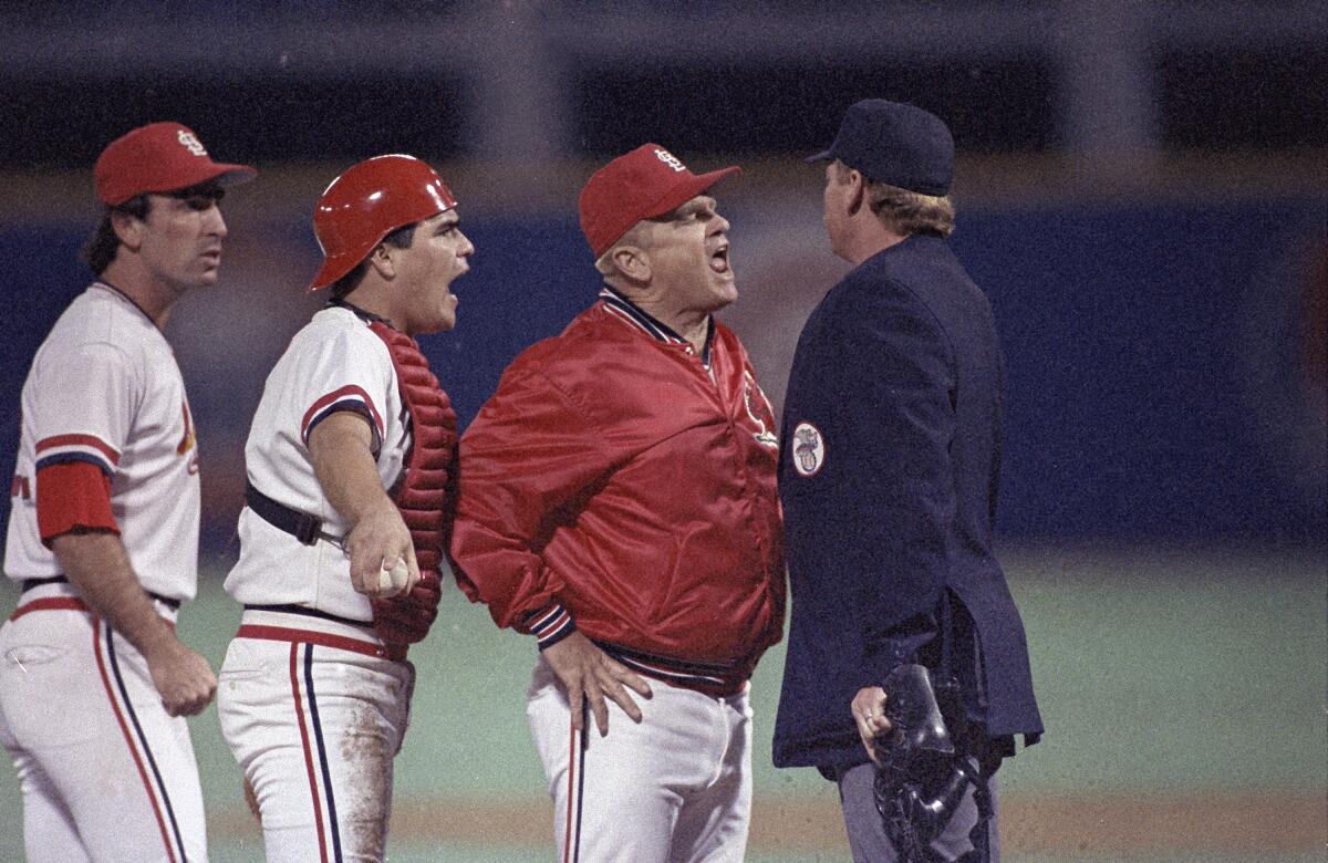 Cardinals manager Whitey Herzog argues with umpire John Shulock with two of his players behind him.