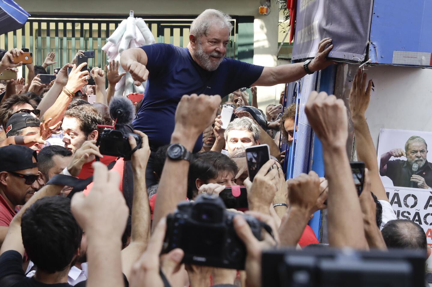 Brazilian former President Luiz Inacio Lula da Silva is carried aloft by supporters outside the Metal Workers Union headquarter in Sao Bernardo do Campo, Brazil on Saturday.
