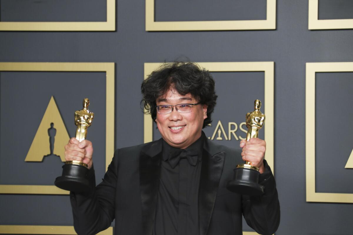 Bong Joon Ho with two of his Oscars.