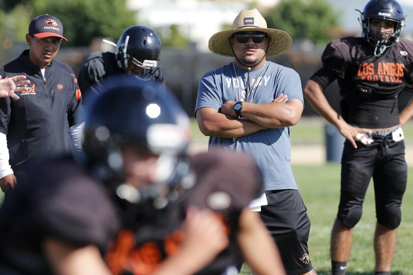 Los Amigos High head coach Maopu Tuato looks on during practice at Los Amigos High in Fountain Valley on Friday.