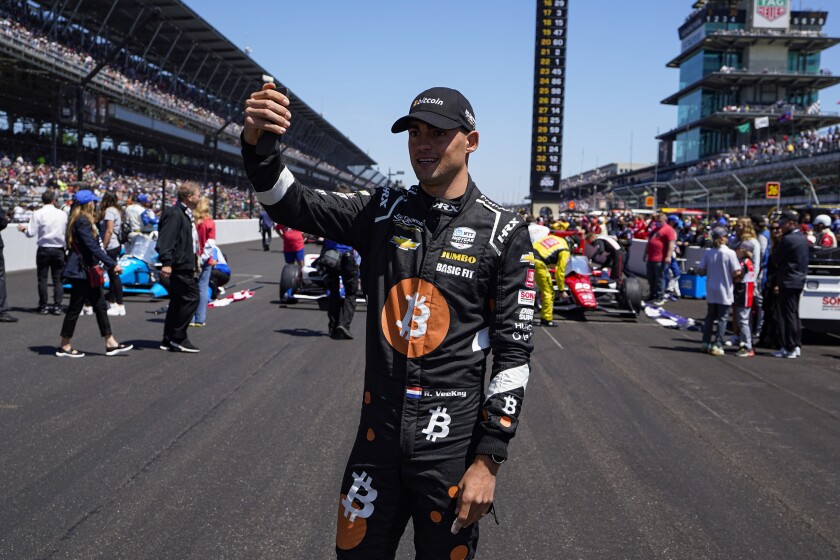 Rinus VeeKay, of the Netherlands, takes a photo as he walks to his car on the grid before the Indianapolis 500 auto race at Indianapolis Motor Speedway in Indianapolis, Sunday, May 30, 2021. (AP Photo/Michael Conroy)