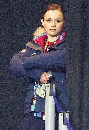 Sasha Cohen, of the United States, watches a group warm up before her turn during the women's free skate.